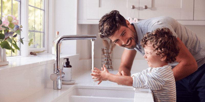 Father and child washing their hands